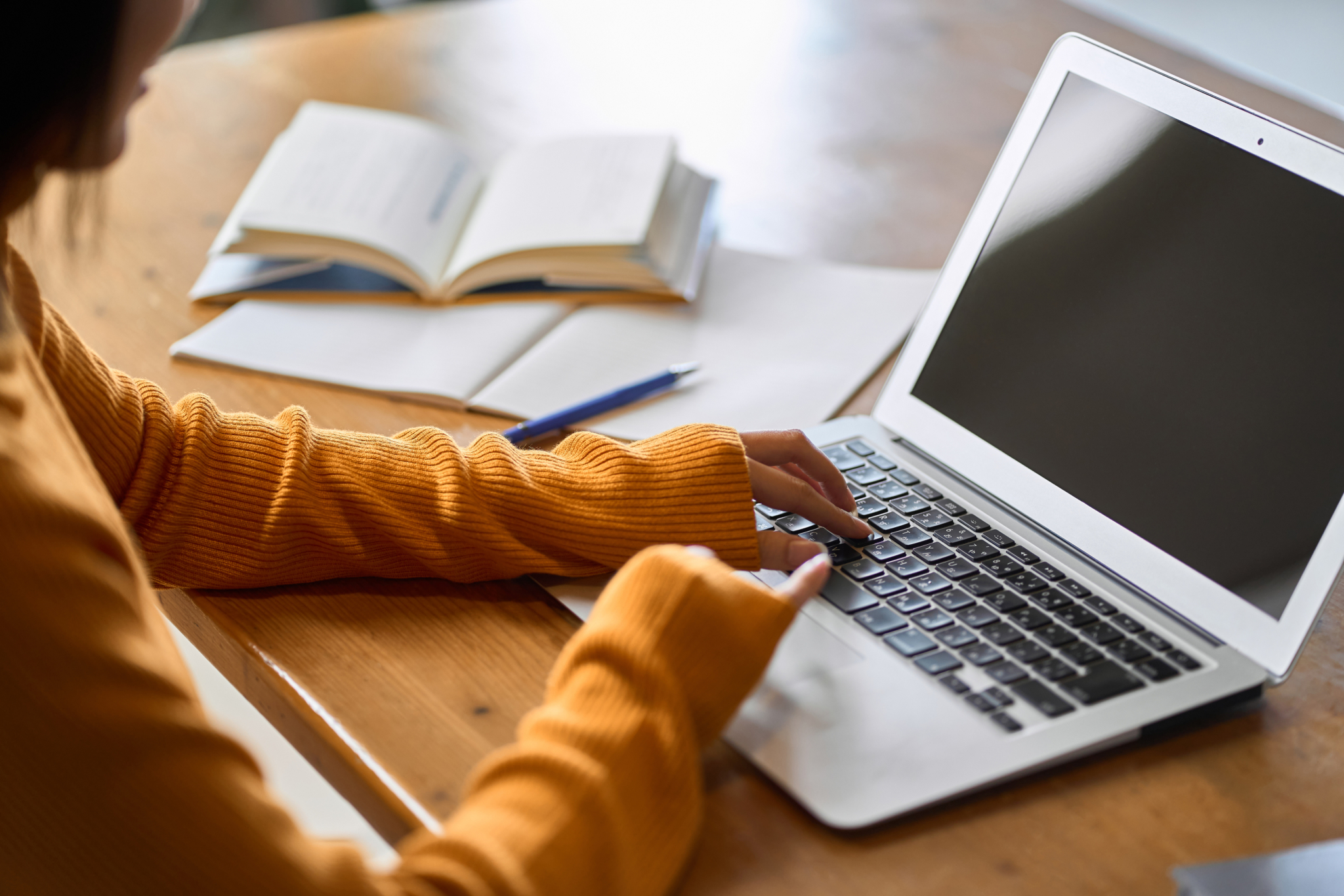 Person researching on a laptop.